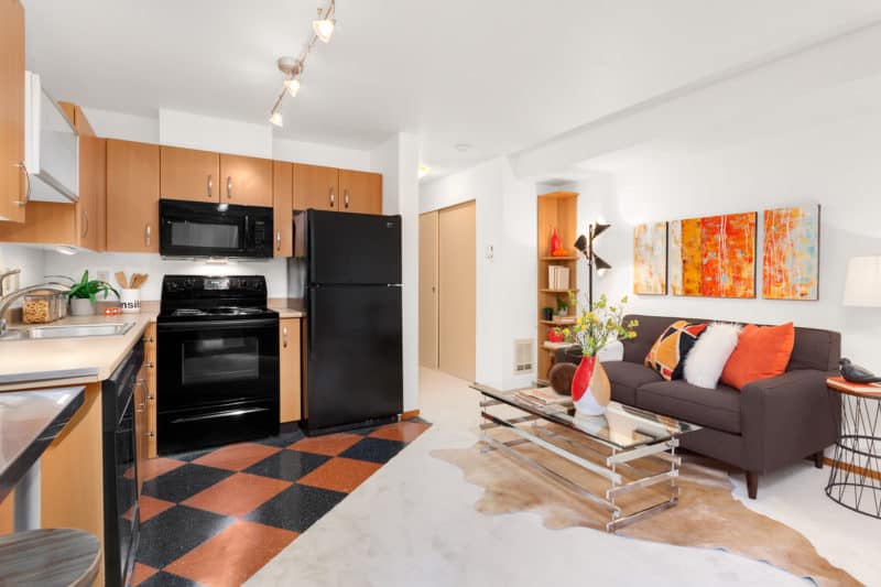 Living area and kitchen in Aurora Condo