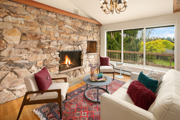 staged long in midcentury living room with stone feature wall