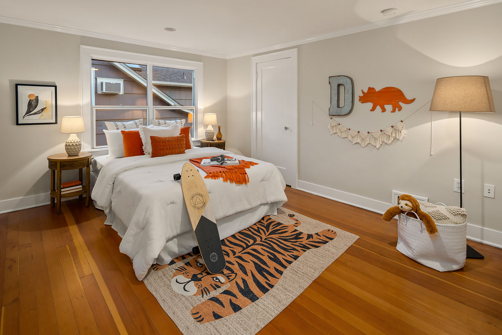 staged kid's bedroom with fun and playful accessories such as a tiger area rug