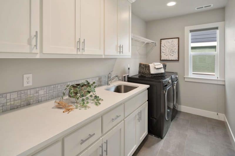 Laundry room with white shelves
