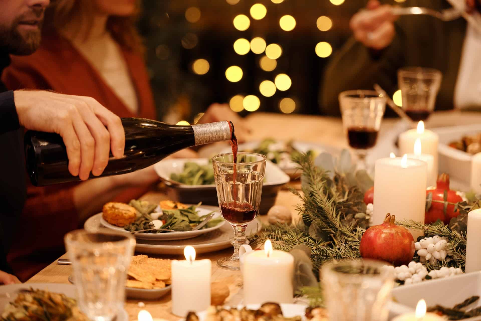 people eating a Christmas dinner at a beautifully decorated dining room table