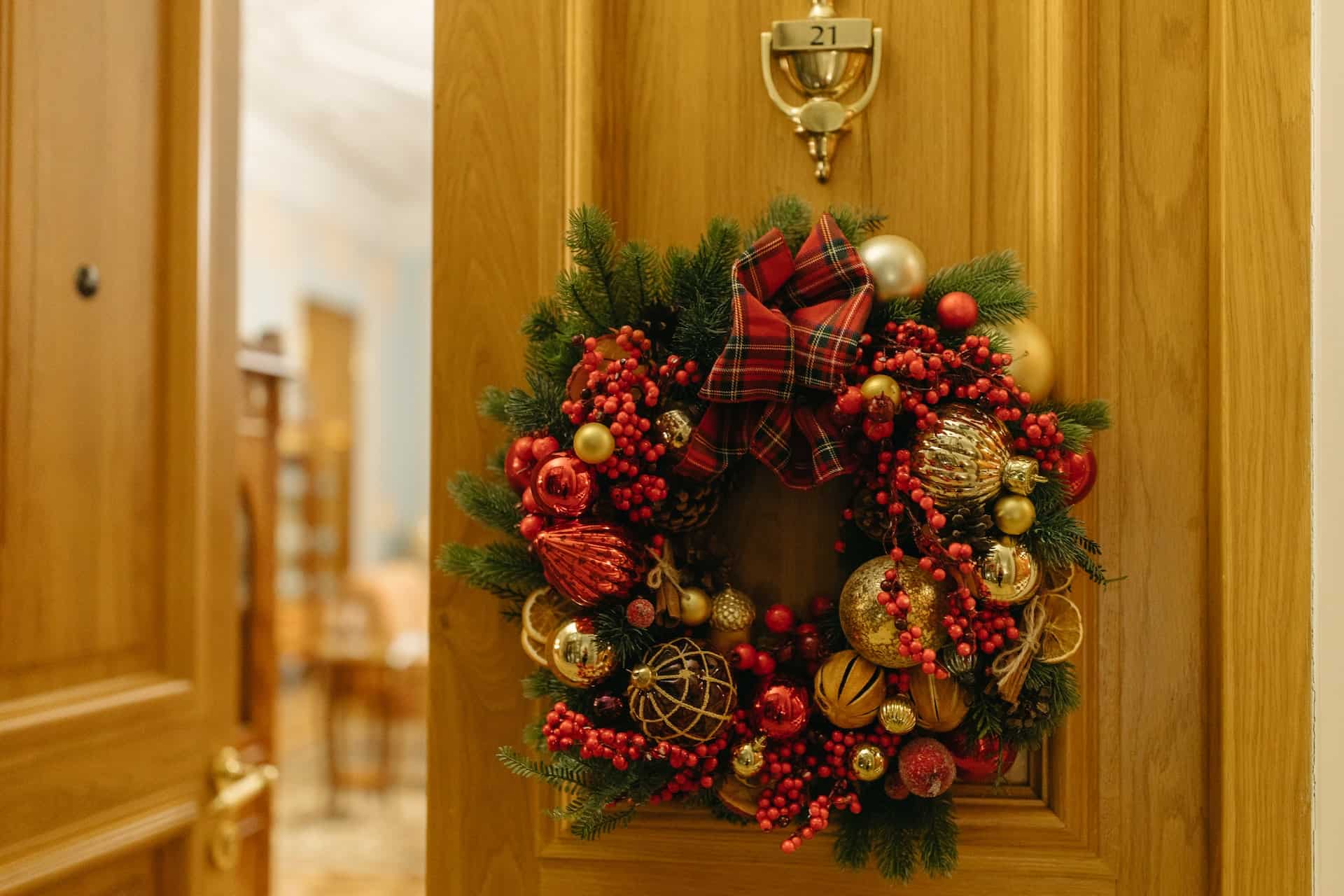 a wreath decorated with red and golden ornaments