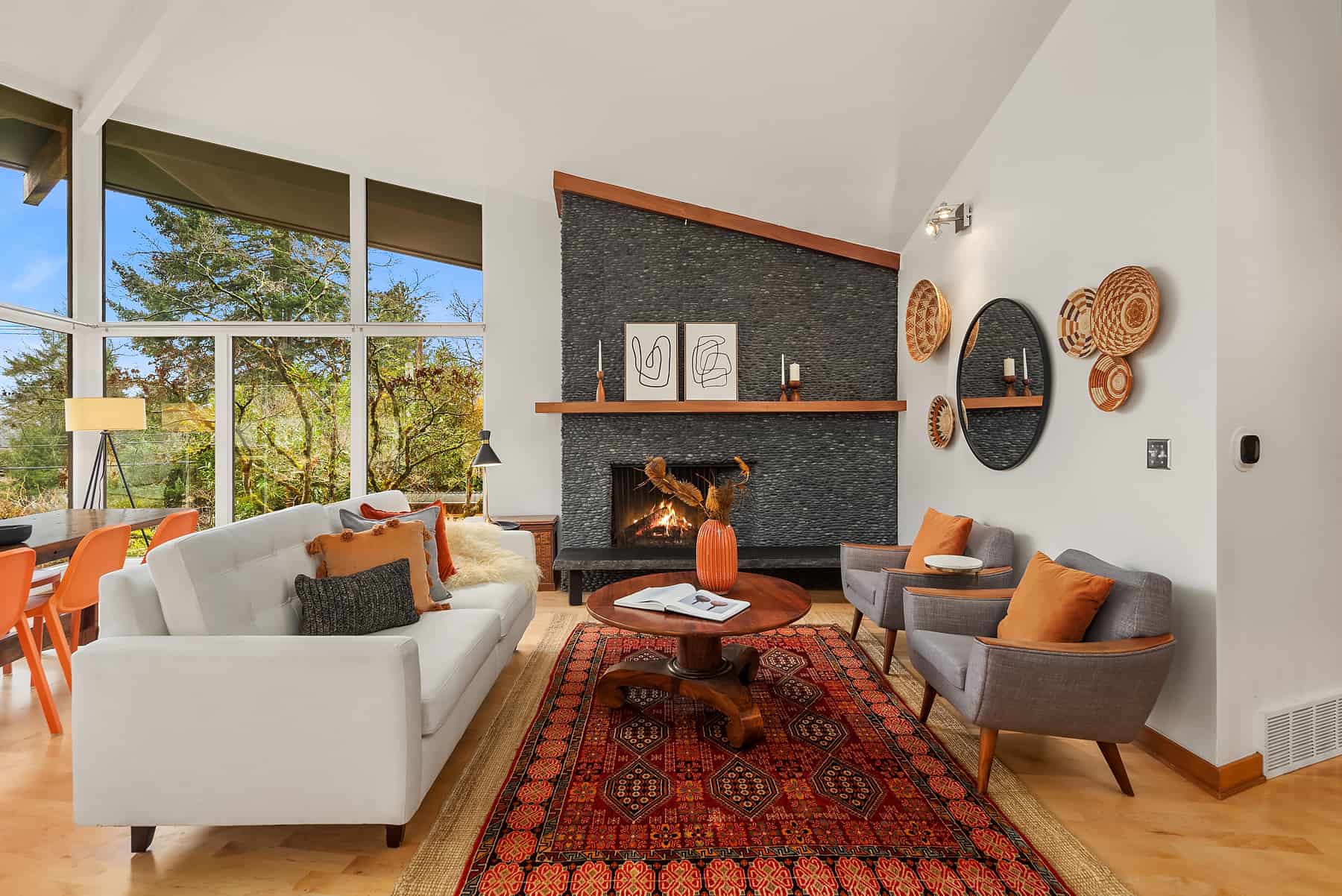 staged luxury midcentury living room with cream sofa and stone fireplace